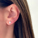 Diamond Illusion Marquise Stud Earrings in 14k yellow gold styled on ear lobe of model