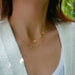 9 Prong Set Diamond Necklace in 14k yellow gold styled on neck of model