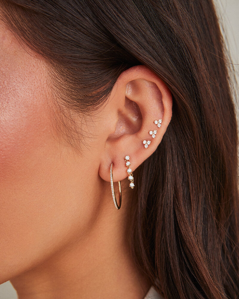 EF Collection 14k yellow gold earrings with diamonds styled on ear lobe of model