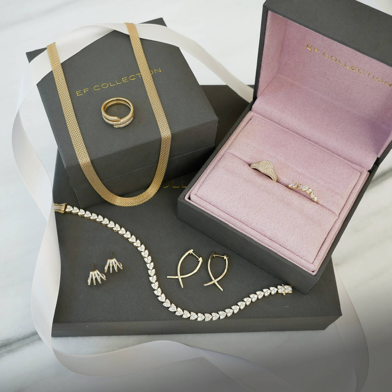 EF Collection 14k yellow gold jewelry with pink and grey jewelry boxes