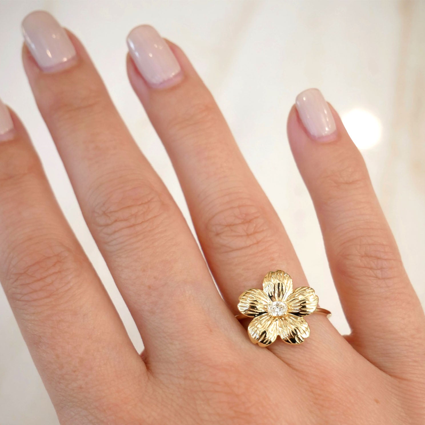 Cherry Blossom Ring in 14k yellow gold styled on ring finger of model