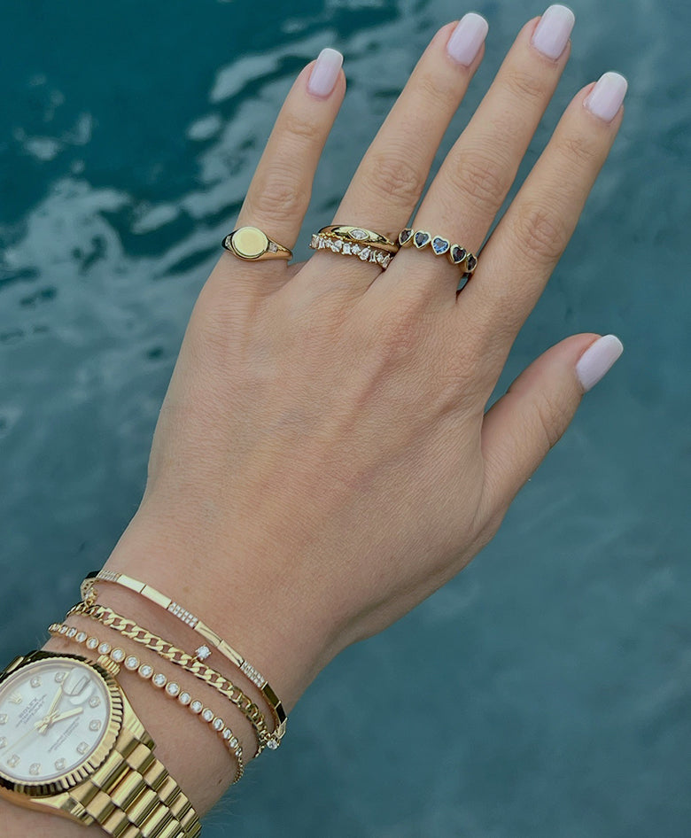 EF Collection 14k yellow gold bracelets and rings styled on hand of model