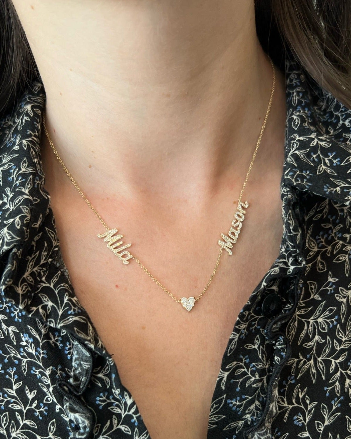 Full Cut Heart Double Diamond Script Name Necklace with names Mila and Mason with heart in the middle of necklace styled on neck of model