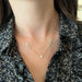 Full Cut Heart Double Diamond Script Name Necklace with names Mila and Mason with heart in the middle of necklace styled on neck of model