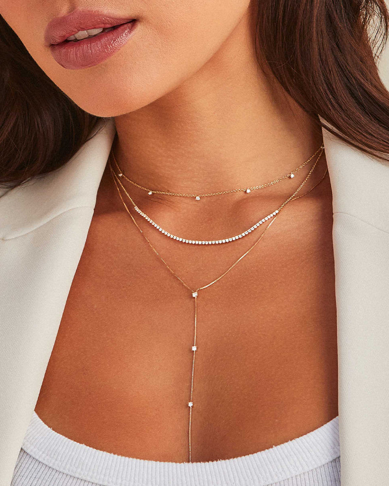 EF Collection 14k yellow gold and diamond necklaces styled on neck of model in white blazer top