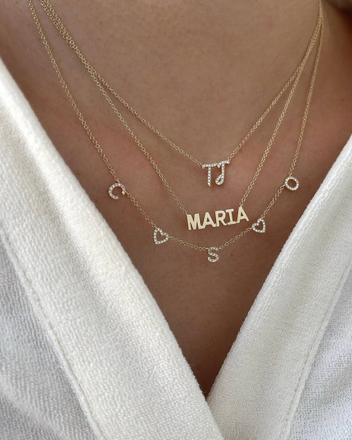 Gold Custom Initial Necklace styled on the neck in yellow gold