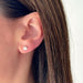 Diamond Illusion Round Stud Earrings in 14k yellow gold styled on ear lobe of model