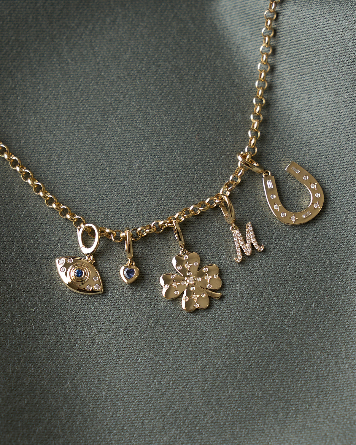 Evil Eye, Mini Blue Sapphire Heart, Diamond Clover, Mini Diamond Script Enhanced Initial, and Diamond Horseshoe Clip Charms on Rolo Chain Necklace