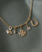Evil Eye, Mini Blue Sapphire Heart, Diamond Clover, Mini Diamond Script Enhanced Initial, and Diamond Horseshoe Clip Charms on Rolo Chain Necklace