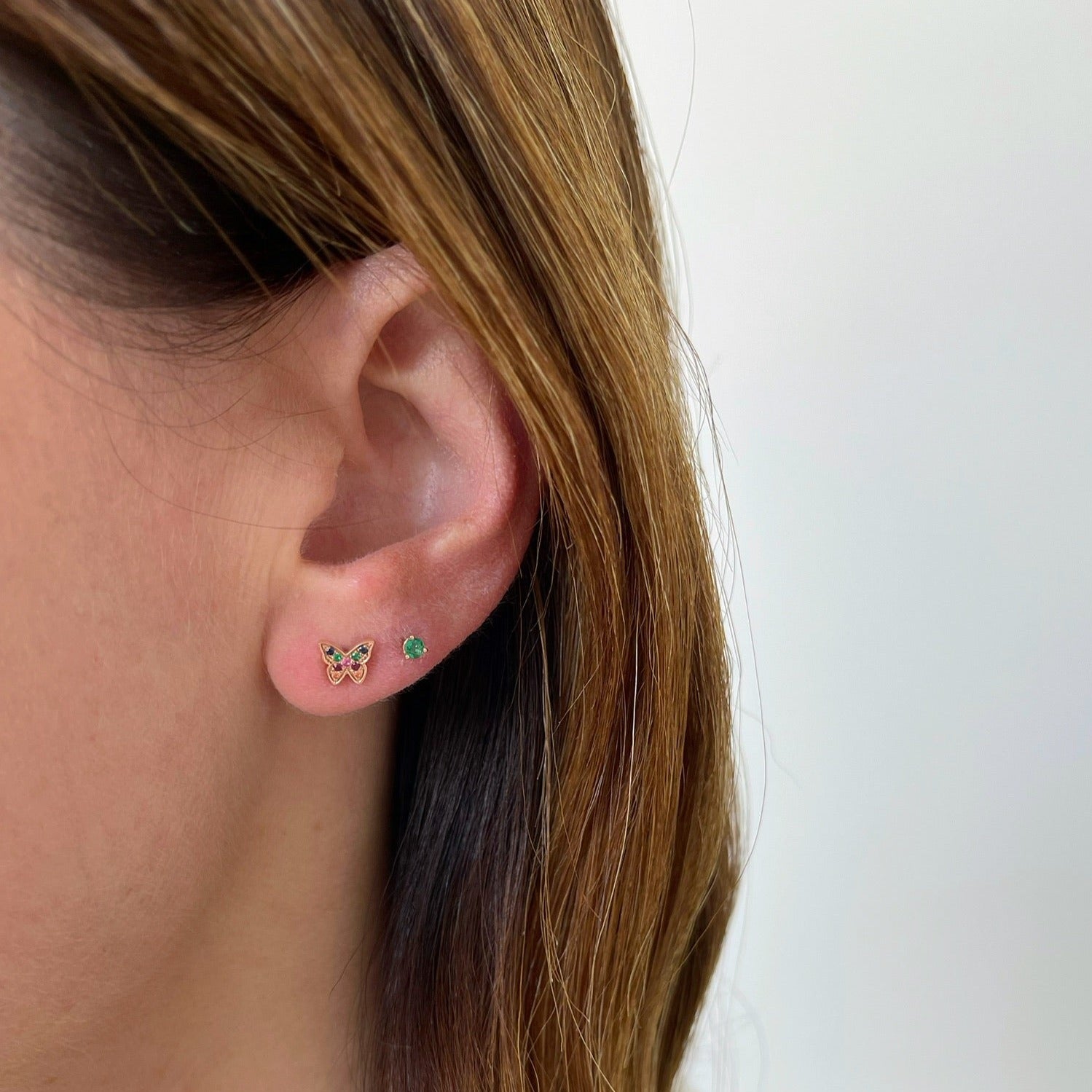 Mini Rainbow Butterfly Stud Earring styled on ear of model