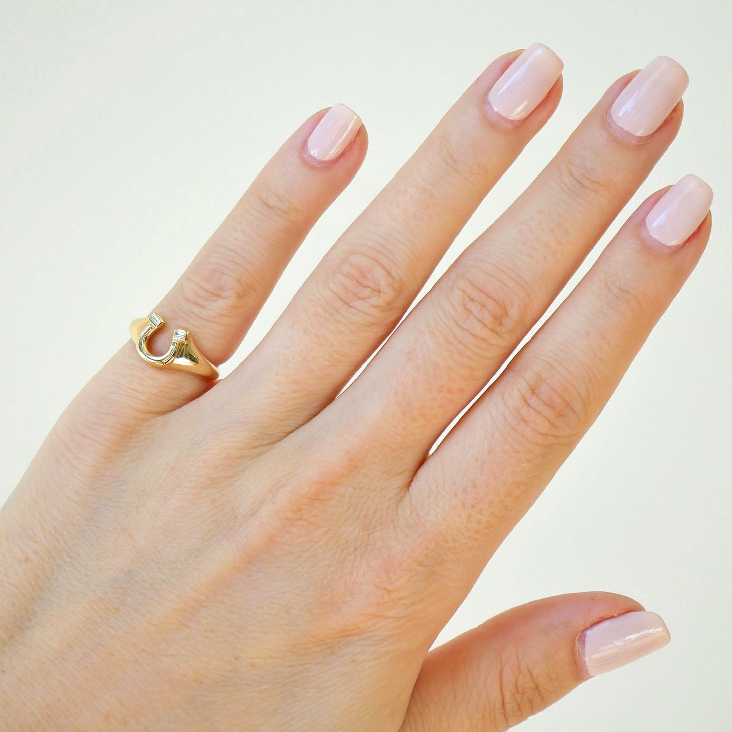 Lucky Horseshoe Signet Ring styled on pinky finger of model