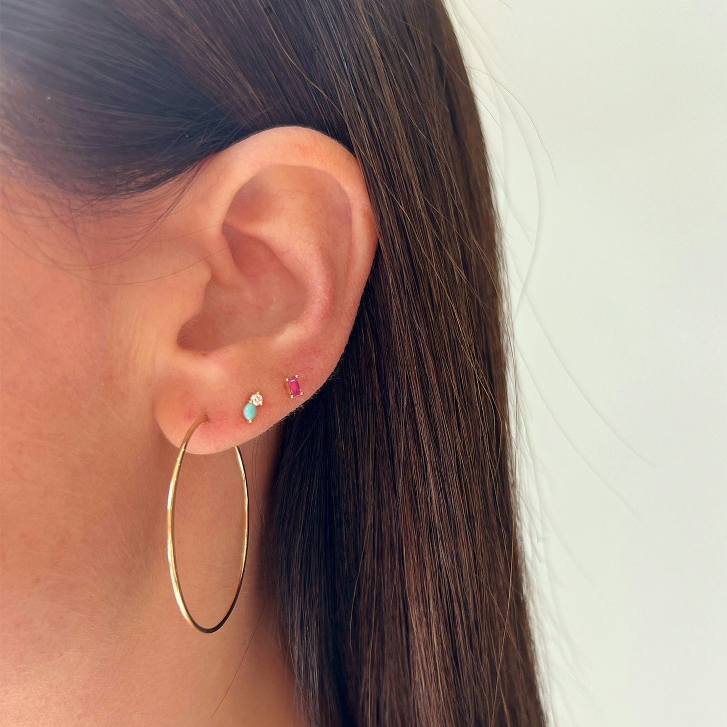 Double Treasure Stud Earring styled on second earring hole of model with gold hoop and pink stud earring