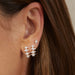 Diamond & Pearl Arc Stud Earring styled on first and second hole on ear lobe of model