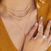Gold Mesh Necklace in 14k yellow gold styled with a diamond necklace and lariat necklace on a model wearing mustard yellow top