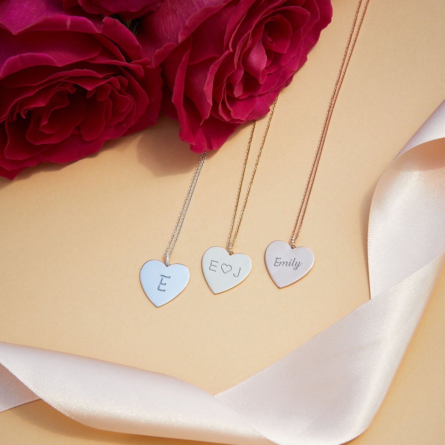 Gold Jumbo Heart Necklace in 14k yellow gold, white gold, and rose gold engraved with initials E, E heart J, Emily