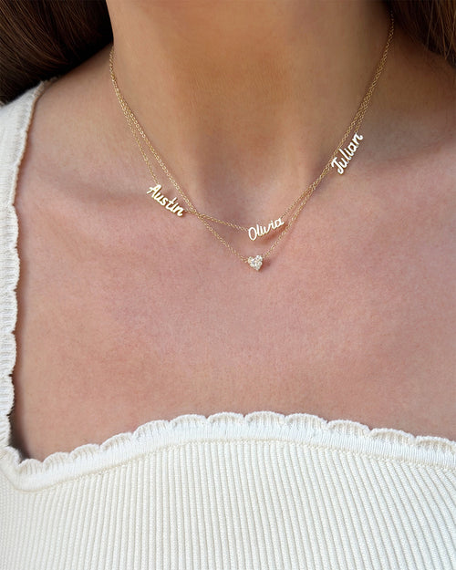 Personalized Mini Gold Script Name Necklace in Yellow Gold with Austin, Olivia, and Julian and Full Cut Heart Diamond Necklace