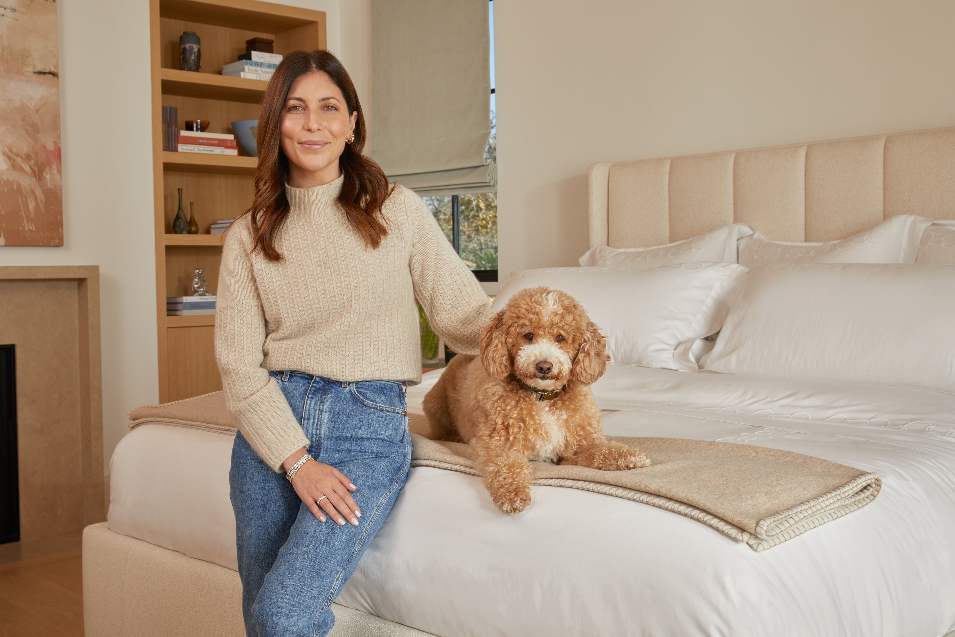 Clove & Ivory Reversible Stitch Throw Blanket displayed on bed with person and dog