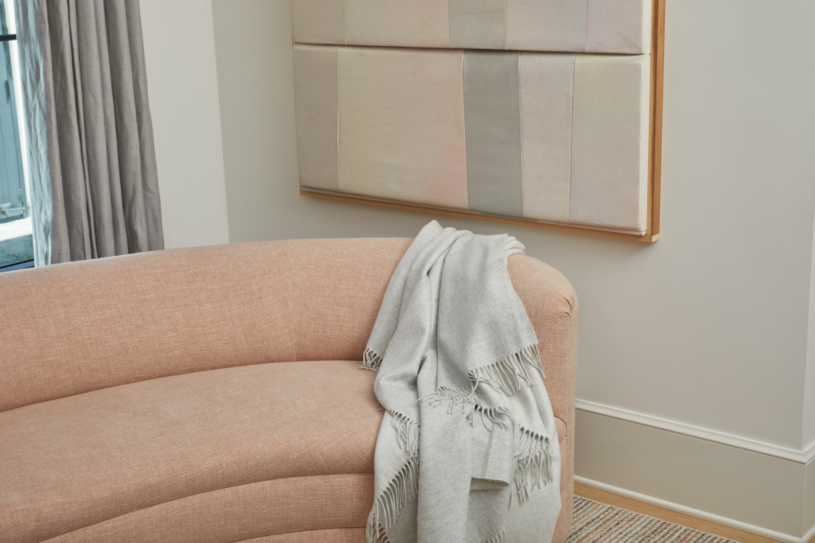 LIGHT GREY & IVORY REVERSIBLE CASHMERE THROW BLANKET DISPLAYED ON COUCH
