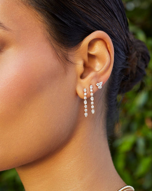 Triple Diamond Cluster Stud Earrings in 14k yellow gold styled on third earring hole on ear lobe of model