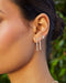 Triple Diamond Cluster Stud Earrings in 14k yellow gold styled on third earring hole on ear lobe of model
