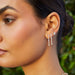 Triple Diamond Cluster Stud Earrings in 14k yellow gold styled on third earring hole on ear lobe of model