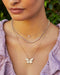 Triple Diamond Cluster Necklace in 14k rose gold styled on neck of model with diamond twist necklace and jumbo butterfly necklace