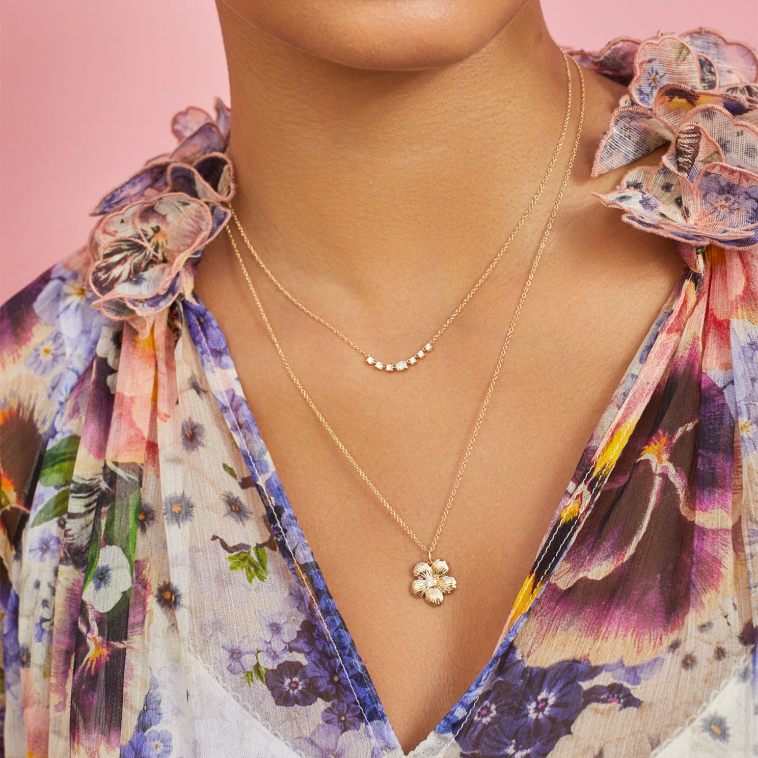Cherry Blossom Necklace in 14k yellow gold styled on neck of model in floral blouse