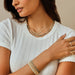 Ombré Tourmaline Birthstone Bead Necklace in 14k yellow gold styled on neck of model with gold and diamond necklace on model in white tshirt