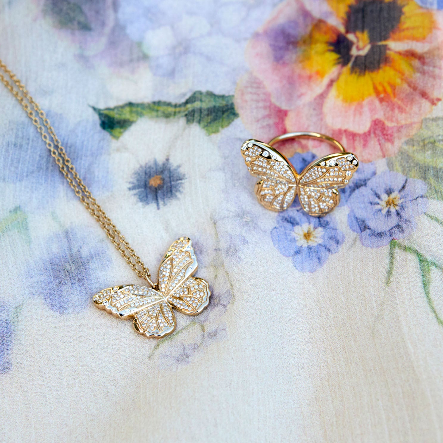 Pavé Diamond Jumbo Butterfly Ring in 14k yellow gold next to jumbo butterfly necklace
