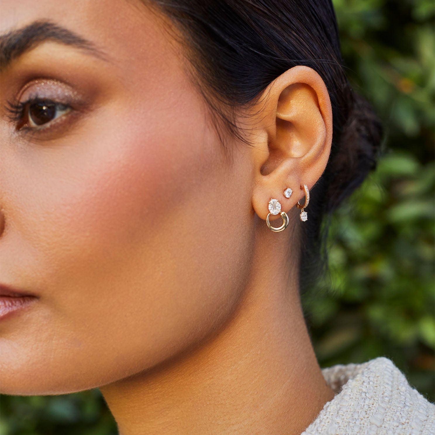 Diamond Oval Stud Earring styled on second earring hole with diamond and gold earrings styled on ear