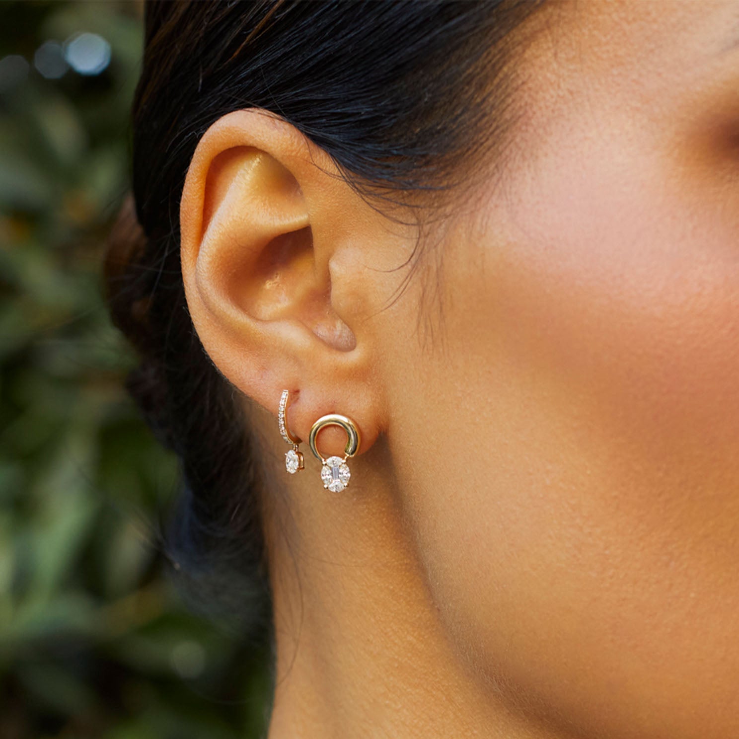 The Iris Illusion Stud Earrings in 14k yellow gold styled on first earring hole on ear lobe of model