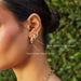 Gold Jumbo Dome Hoop Earrings in 14k yellow gold styled on ear lobe of model next to gold jumbo dome hugige earring and diamond pillow huggie earring