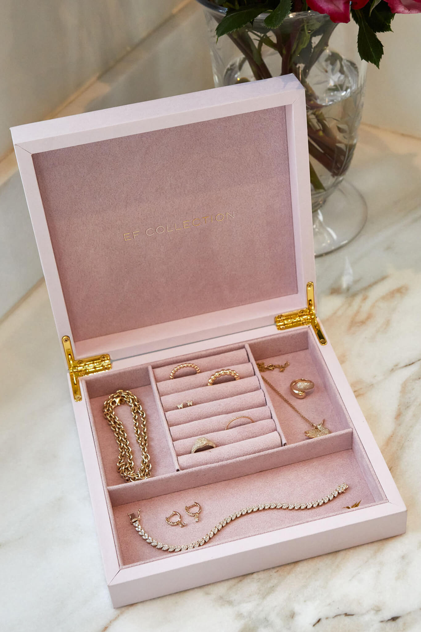 EF Collection 14k yellow gold rings, bracelets, earrings, and necklaces inside pink jewelry box