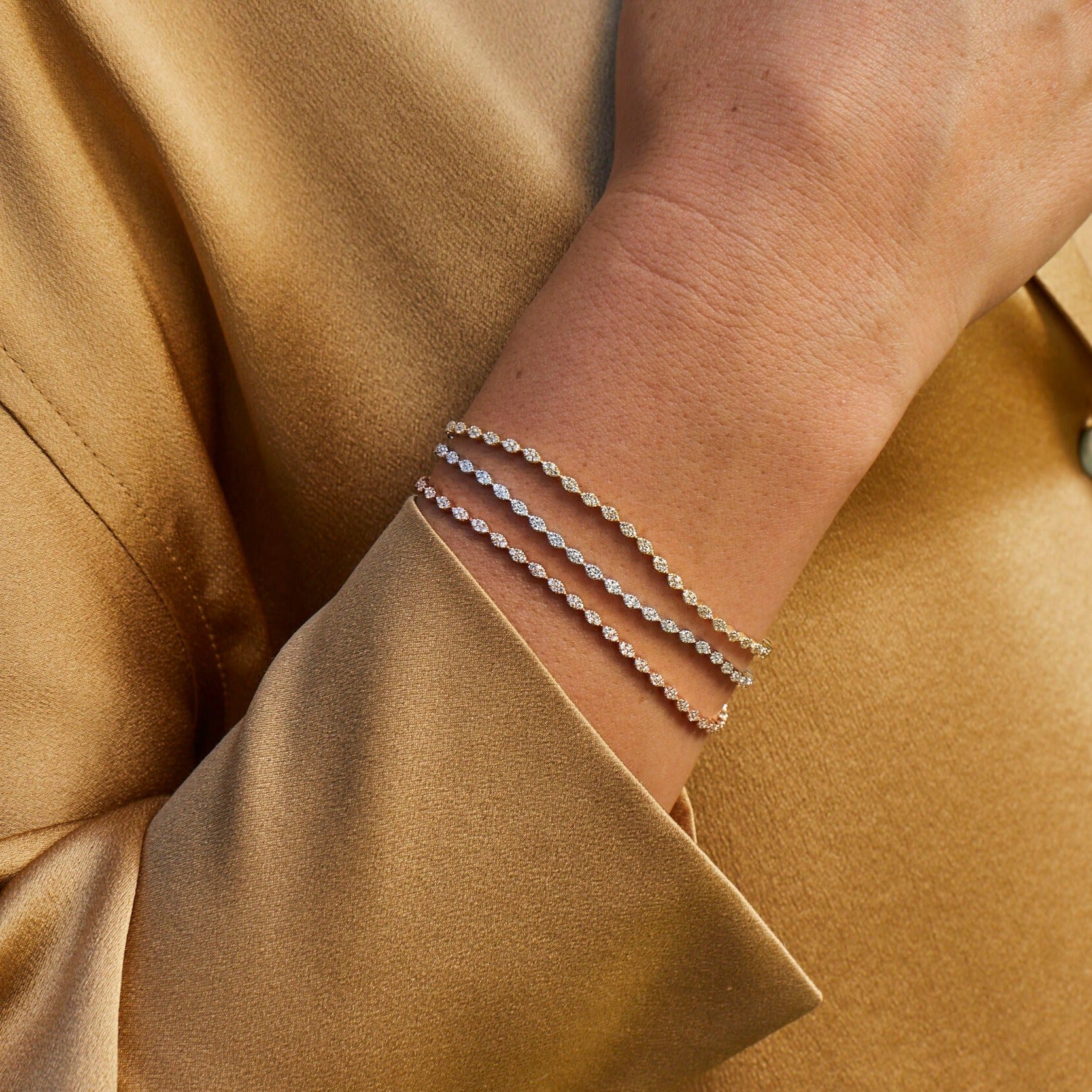 Pavé Diamond Marquise Eternity Bracelet in yellow gold, rose gold, and white gold styled on wrist of model