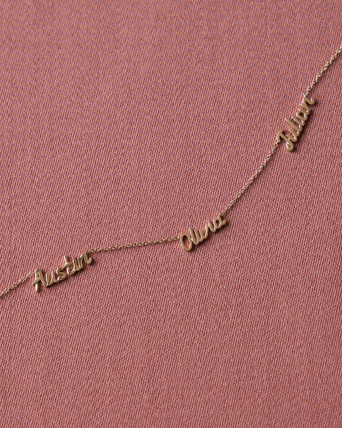 Personalized Mini Gold Script Name Necklace in Yellow Gold with Austin, Olivia, and Julian