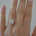 The Lindsay Engagement Ring with round center diamond and yellow gold band styled on ring finger of model