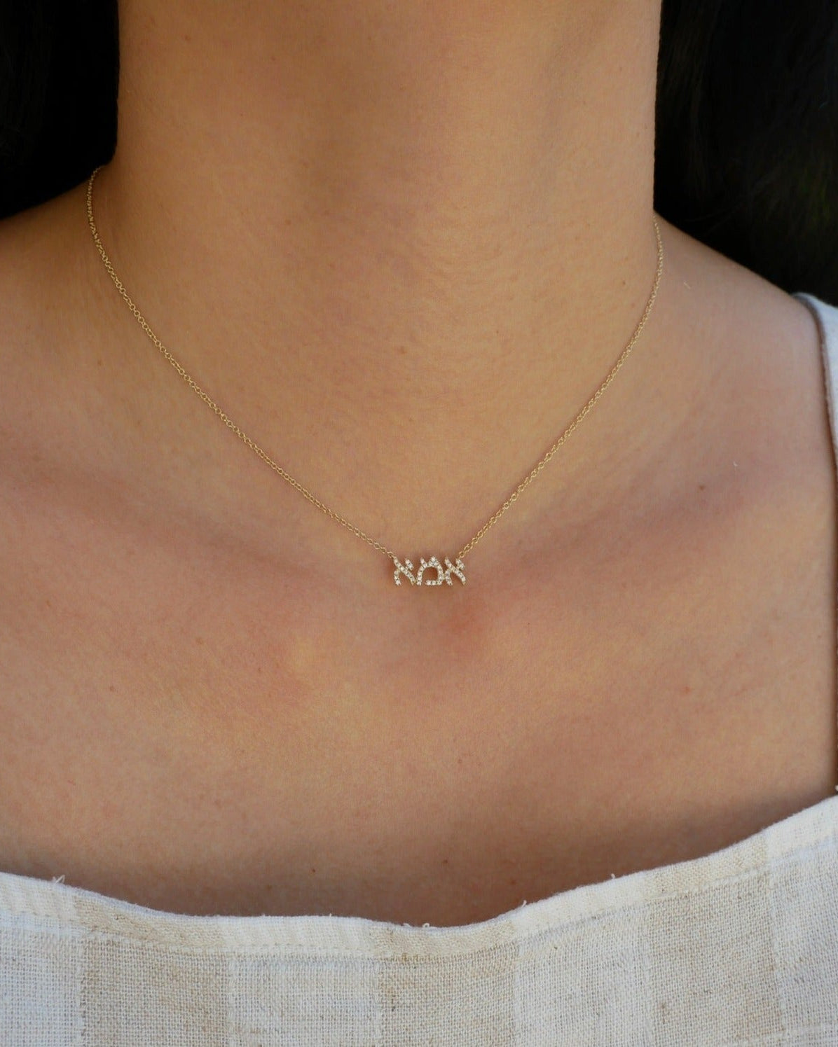 Diamond Hebrew Mom Necklace in 14k yellow gold styled on neck of model