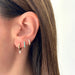 Reversible Diamond & Turquoise Mini Huggie Earring in 14k yellow gold styled on second and third earring holes of model