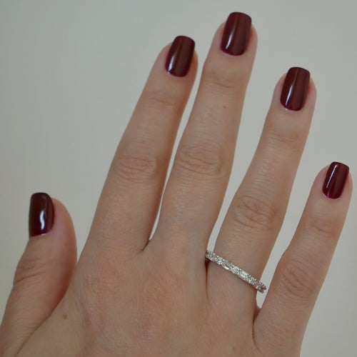 Round & Emerald Diamond Eternity Band in 18k white gold styled on ring finger of model