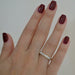 Emerald Cut Beaded Bezel Eternity Band in 18k yellow gold styled on ring finger of model