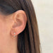 Double Prong Set Diamond Earring styled on ear lobe of model