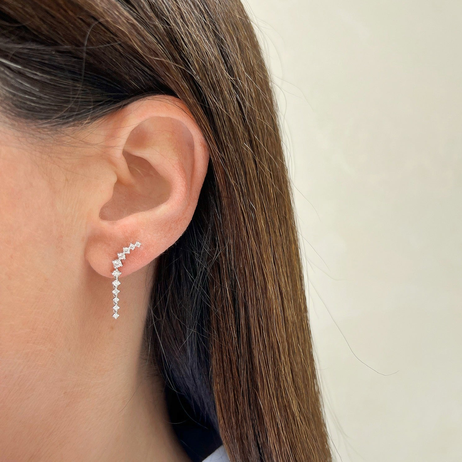 Prong Set Diamond Waterfall Earring in 14k white gold styled on ear lobe of model