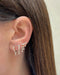 Prong Set Double Drop Huggie Earrings in 14k yellow gold styled on first and second earring hold on ear lobe of model next to diamond dangle stud earring