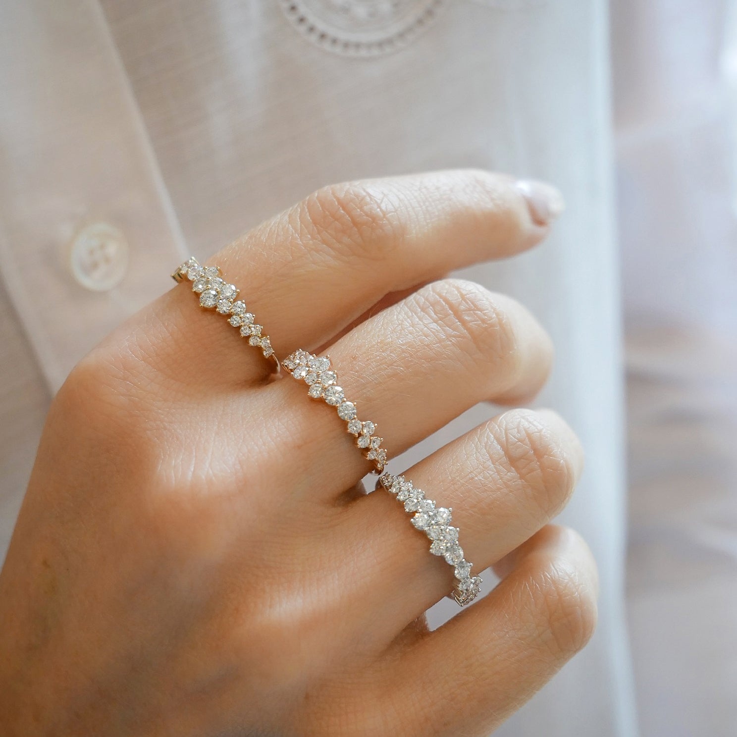 Diamond Cluster Ring in 14k yellow gold, rose gold, and white gold styled on fingers of model