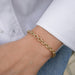 Sienna Chain Bracelet in 14k yellow gold styled on wrist of model in white blouse