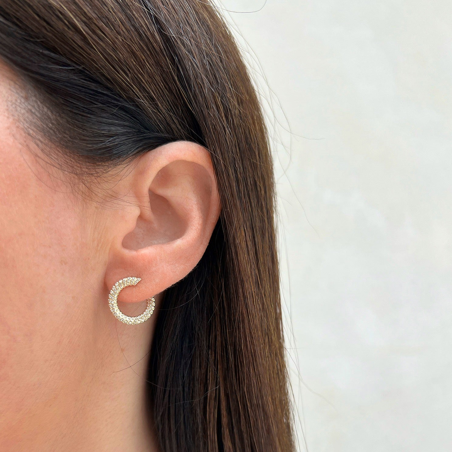 Diamond Twist Wrap Earring in 14k yellow gold styled on ear lobe of model