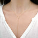 Diamond Pillow Lariat Necklace in 14k yellow gold styled on neck of model