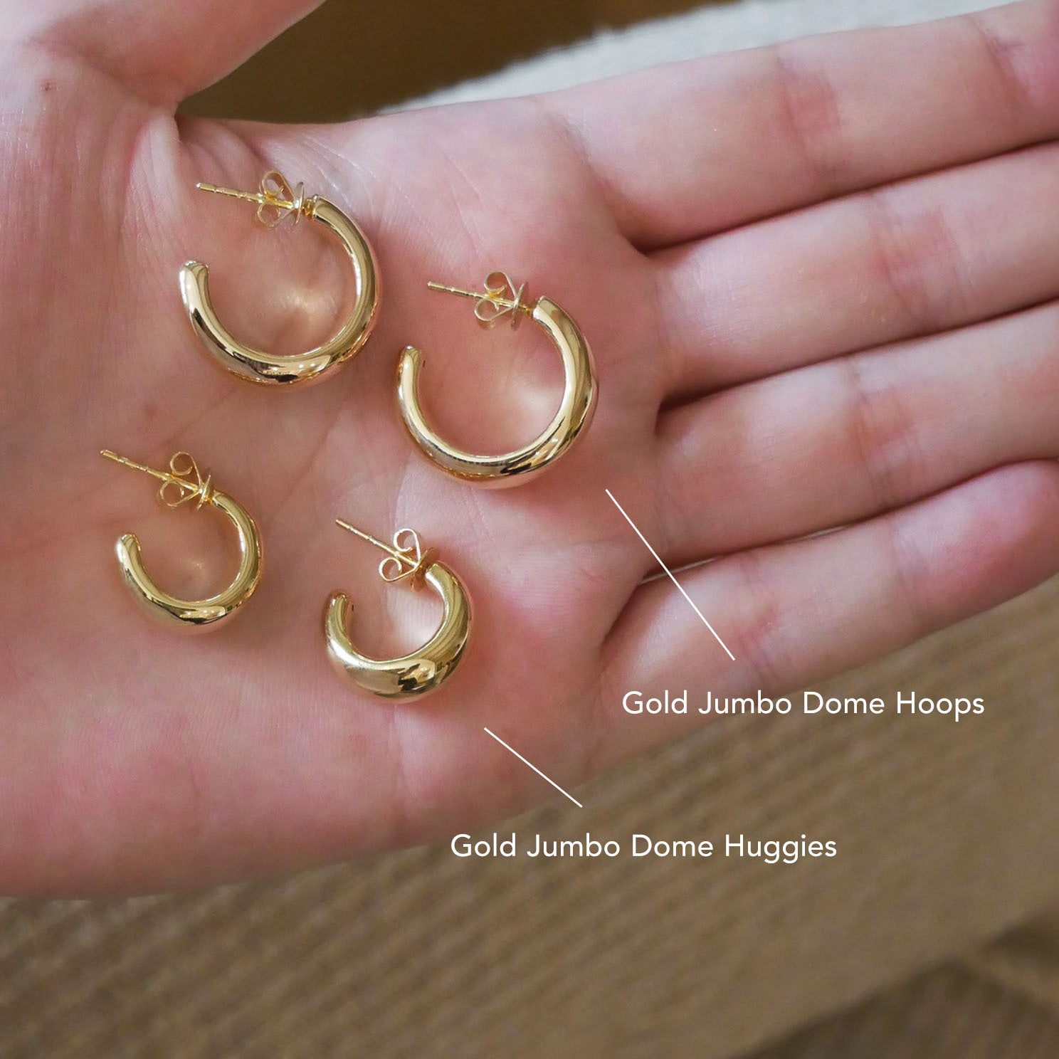 Gold Jumbo Dome Hoop Earrings in 14k yellow gold next toGold Jumbo Dome Huggie Earrings in 14k yellow gold