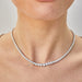 Diamond Riviera Tennis Necklace in 18k white gold with 11.7 carat diamonds styled on neck of model