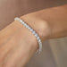 Diamond Tennis Bracelet in 18k white gold in 12 carat diamonds styled on wrist of model